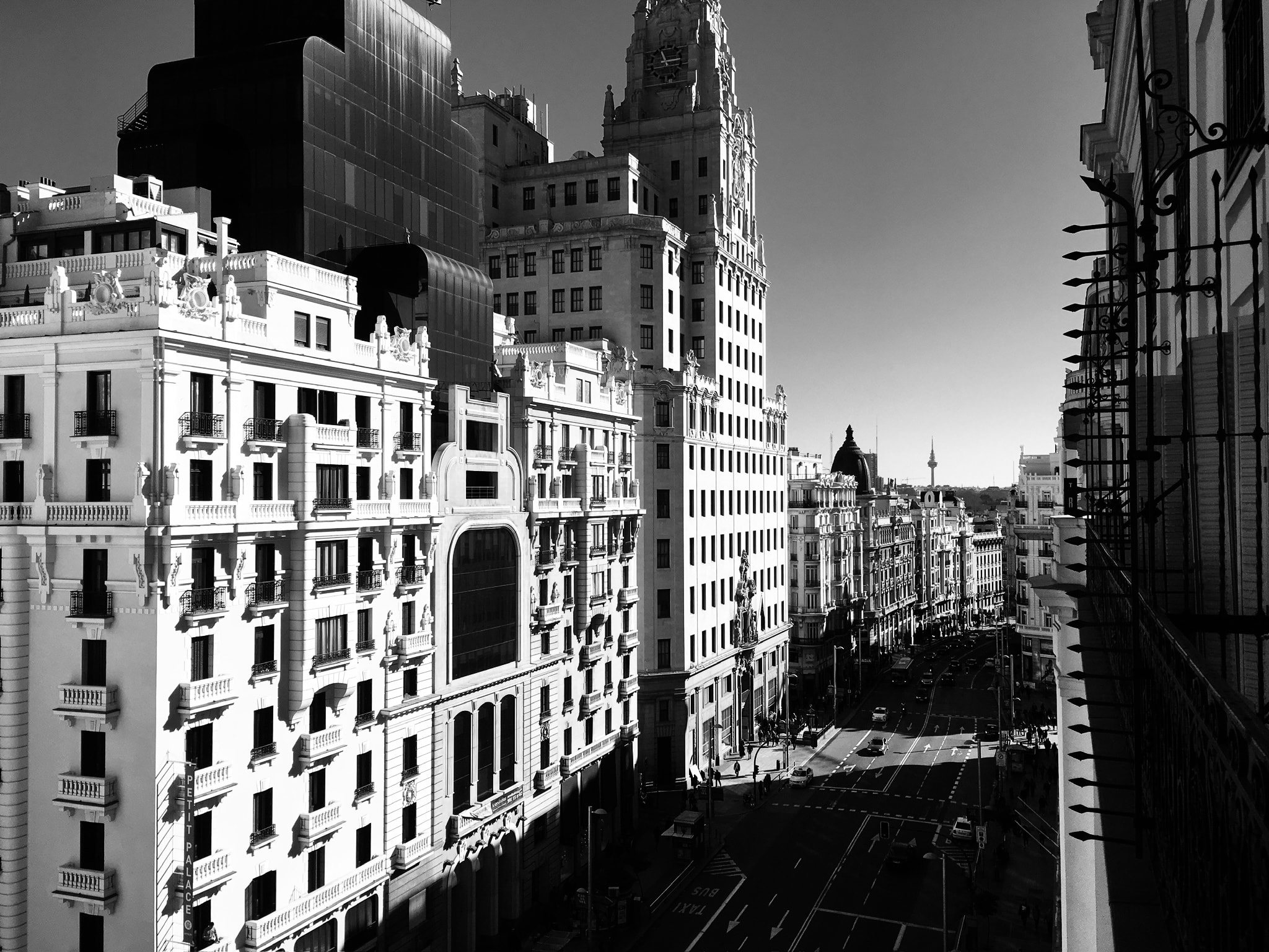 Black and white aerial view of a European city street with classical architecture